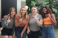 A group of education students show off their student teacher badges.